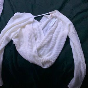 This is a new, never been worn, crossed white sweater. Tag on it!